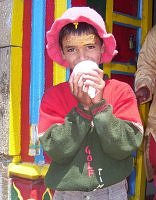 Garhwali Brahmin boy blowing the conch shell outside Madmaheshwar temple, Garhwal Himalaya